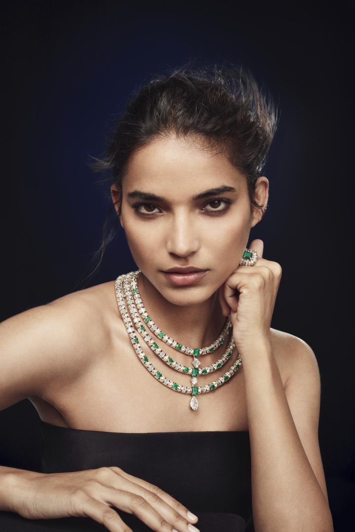  To represent the 400-kilometres journey of roads and forests that separates the Jura area from Paris, the Maison has created this luxuriant jewellery set. On the necklace, the green of the most beautiful Colombian emeralds – which took two years' research to pair – is combined with three rows of platinum, yellow gold and white gold, entirely pavé-set with diamonds. This Damier checkerboard stone marquetry, where each link presents four different settings, is a radiant work of art enhanced by the presence of an LV Monogram Flower and a 5.21-carat DFL pear-shaped diamond of remarkable colour and purity. The necklace, which can be worn in six different ways, took over 1600 hours to complete. It is joined by three rings, a voluptuous bracelet and two pairs of earrings including pendants with exceptional stones, Colombian emeralds and DFL type 2A pear-shaped diamonds with the same weight of 3.19 ct.