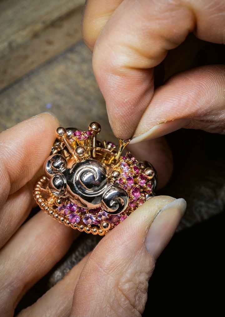 Pre-assembling pink sapphire bezels on the dome's rose gold structure.