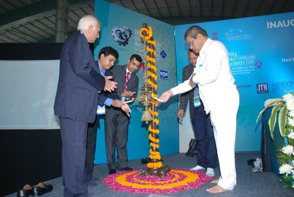 Mr. Dinesh Navadiya, Mr. D.R. Parmar, Shri Nanubhai Vanani, Mr. Chandrakant Sanghavi and Nirav Bhansali seen lighting the lamp.