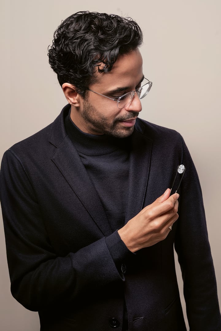 Ravi Bhansali, holding an 8-carat oval-cut D IF Type IIa diamond, originating from the Jwaneng mine in Botswana. As a De Beers Sightholder since 1969, Rosy Blue benefits from access to some of the world's rarest rough diamonds.
