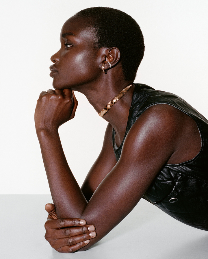 Model Akon Changkou wears a Coco Crush quilted motif supple choker and earring in 18k beige gold, white gold and diamonds.